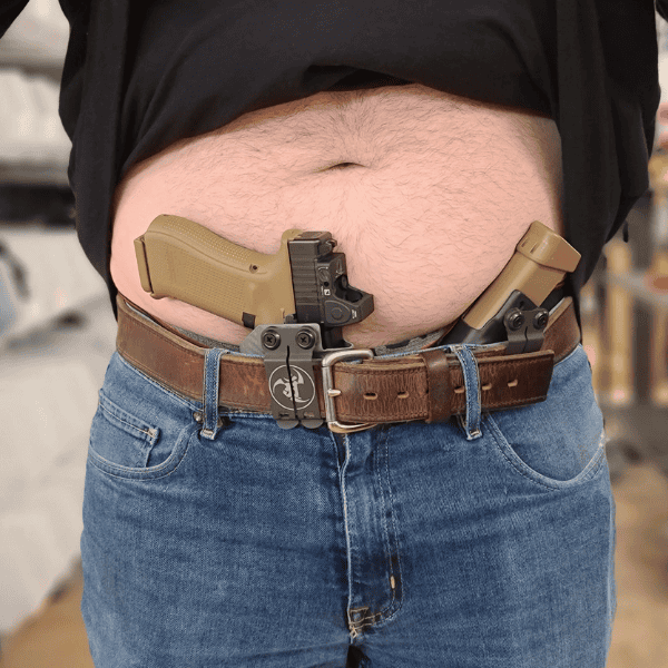 Extended magazine holster with backup gun in waistband, designed for concealed carry.